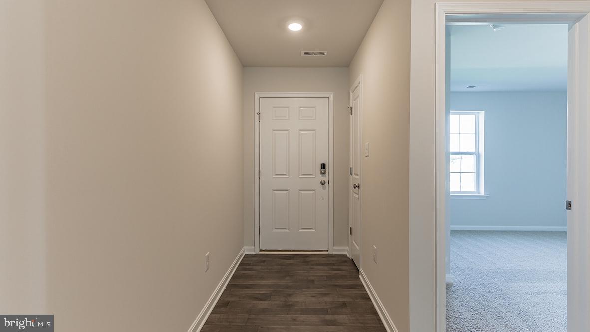 101 Whitman Lane Woodbine, NJ 08270 - Photo 24 of 29 a view of a hallway with wooden floor and closet