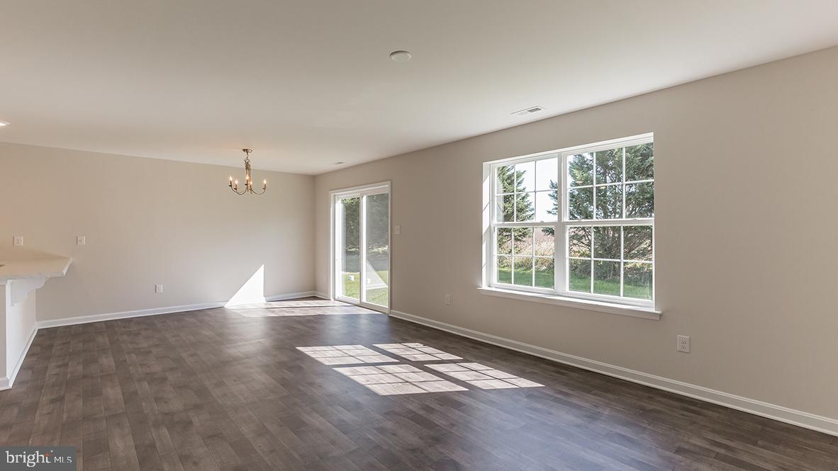 101 Whitman Lane Woodbine, NJ 08270 - Photo 8 of 29 an empty room with wooden floor and windows