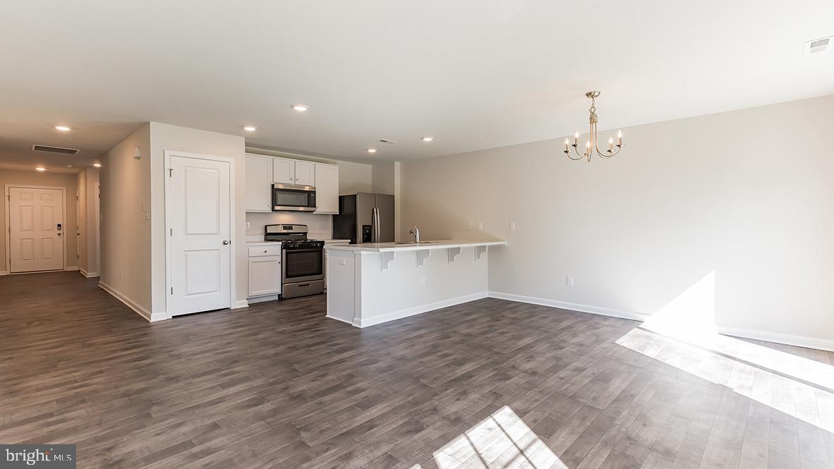 101 Whitman Lane Woodbine, NJ 08270 - Photo 9 of 29 a view of a kitchen with wooden floor and electronic appliances