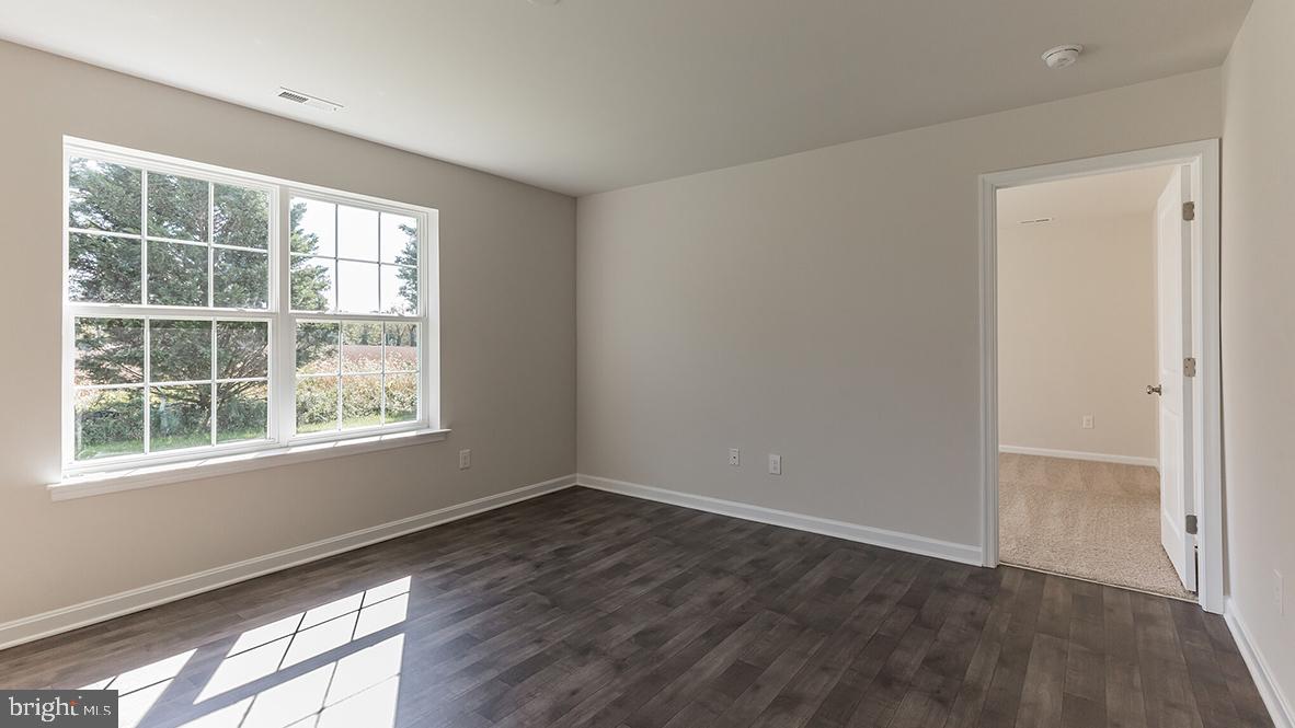 101 Whitman Lane Woodbine, NJ 08270 - Photo 10 of 29 an empty room with wooden floor and windows