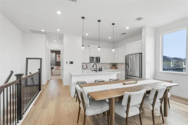 a large kitchen with a table and chairs