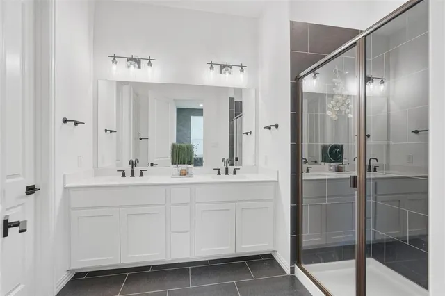 a bathroom with a shower sink and mirror