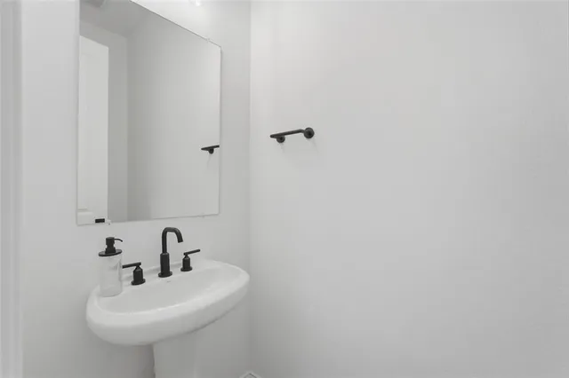 a bathroom with a sink and mirror