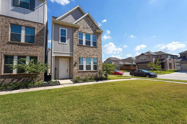 a view of a house with a yard and sitting area