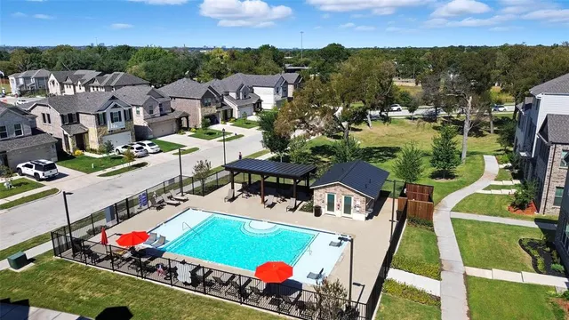 an aerial view of residential houses with outdoor space and river
