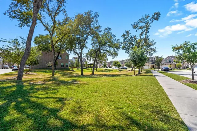 a view of yard with swimming pool and trees