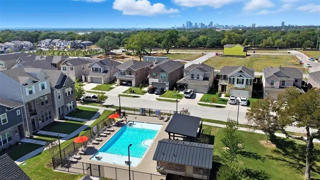 a view of swimming pool with outdoor seating and a city view