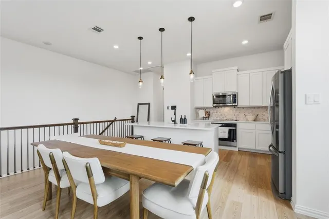 a large kitchen with a table and chairs in it