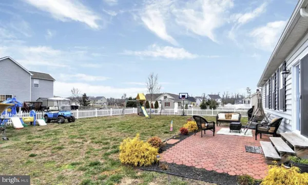 a view of a big yard with table and chairs