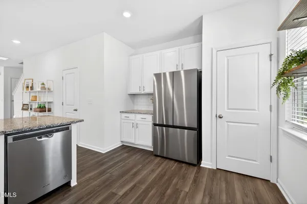 a kitchen with stainless steel appliances a refrigerator and a sink