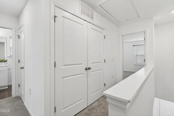 a view of a hallway with closet and entryway