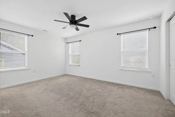 a view of a livingroom with a ceiling fan and window