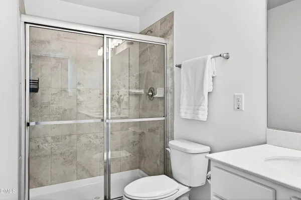a bathroom with a toilet and a shower