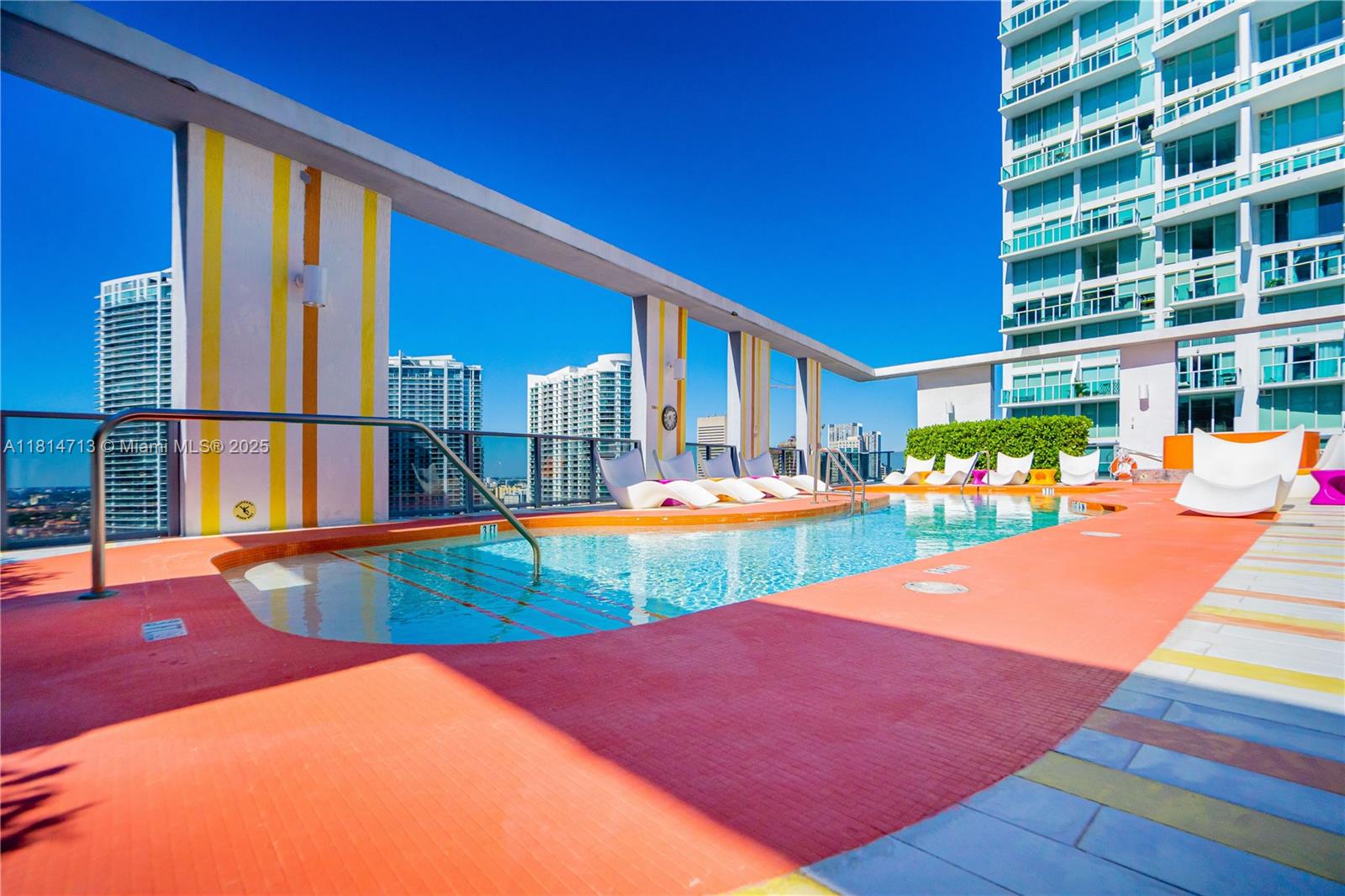 31 Southeast 6th Street, Unit 2205 Miami, FL 33131 - Photo 18 of 25 a view of an chairs and swimming pool in the backyard