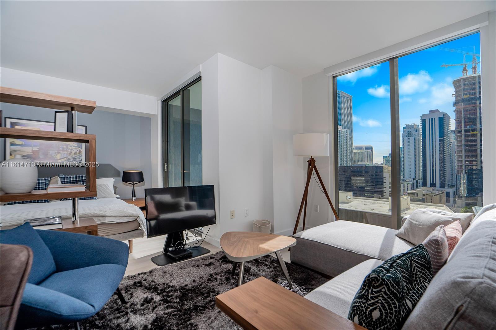 31 Southeast 6th Street, Unit 2205 Miami, FL 33131 - Photo 2 of 25 a living room with furniture and a large window