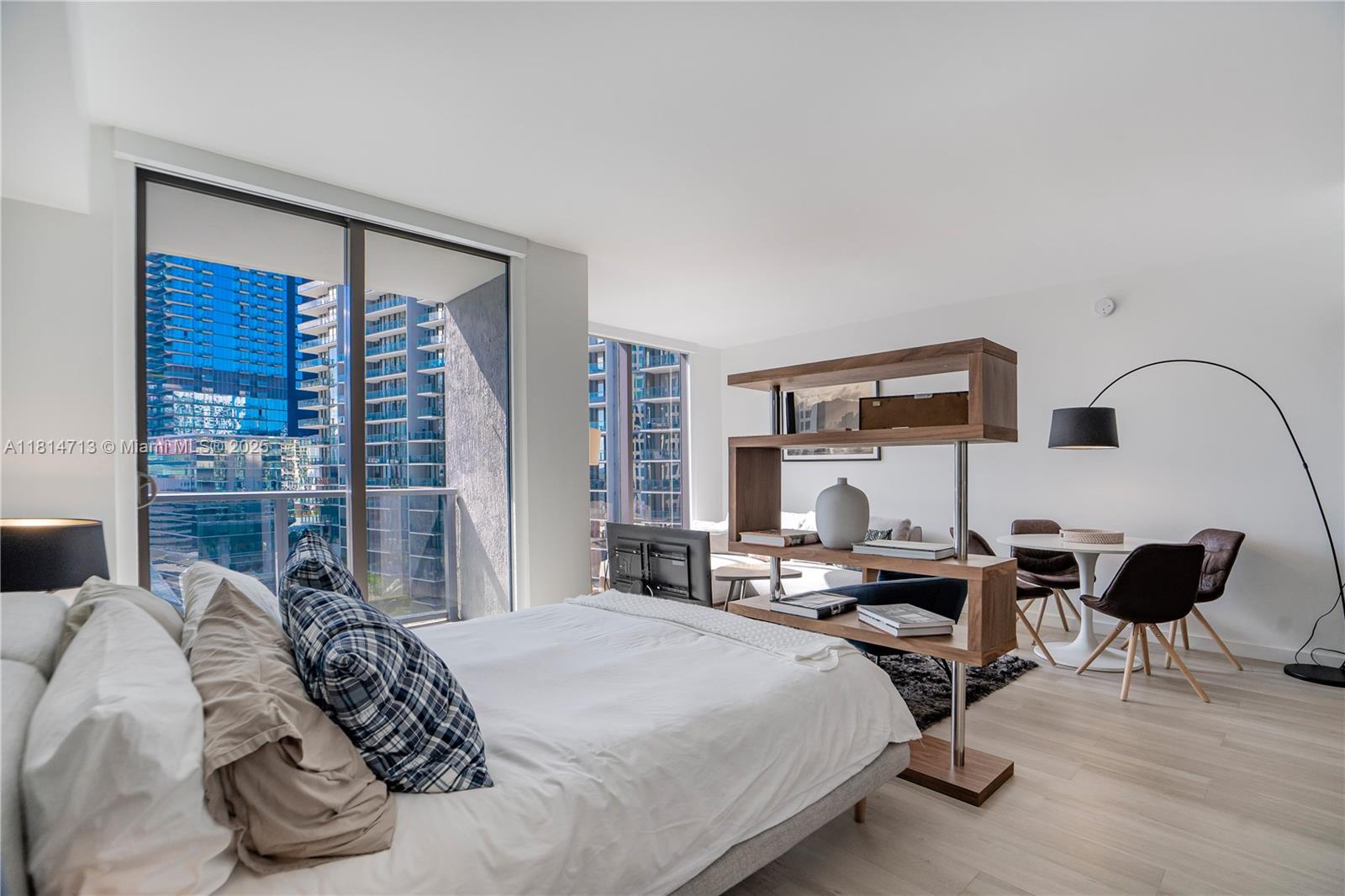 31 Southeast 6th Street, Unit 2205 Miami, FL 33131 - Photo 3 of 25 a bedroom with bed a table and chair