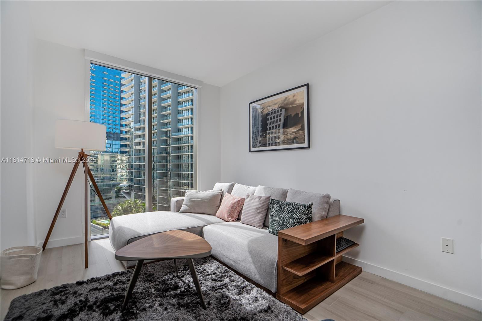 31 Southeast 6th Street, Unit 2205 Miami, FL 33131 - Photo 7 of 25 a living room with furniture and a window