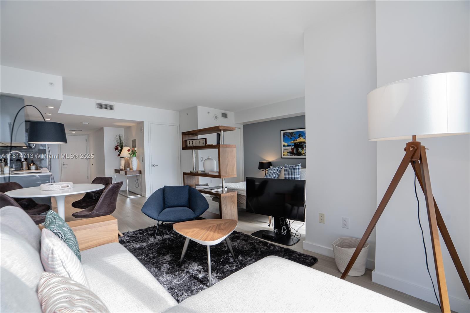 31 Southeast 6th Street, Unit 2205 Miami, FL 33131 - Photo 8 of 25 a living room with furniture and a wooden floor