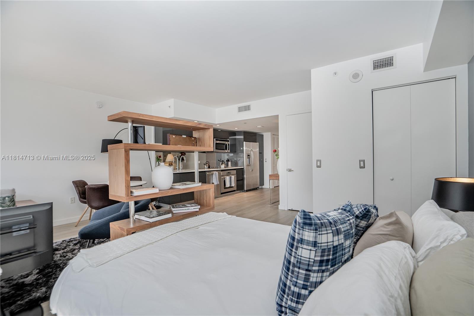 31 Southeast 6th Street, Unit 2205 Miami, FL 33131 - Photo 10 of 25 a bedroom with furniture and a book shelf