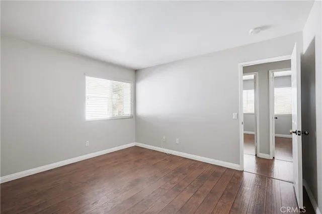 a view of a hallway with closet and wooden floor