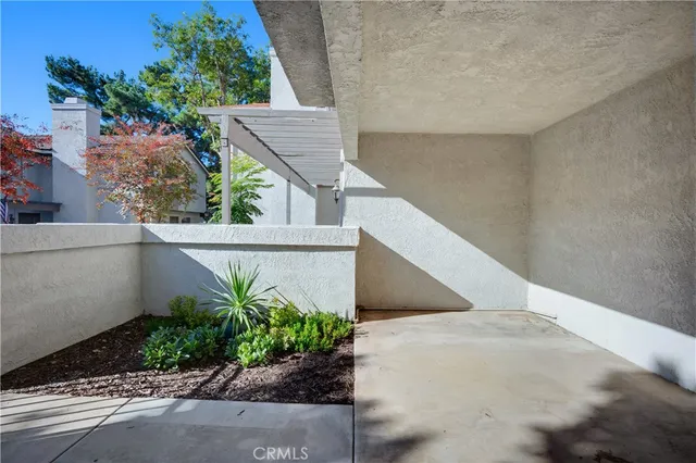 a front view of a house with a yard and potted plants