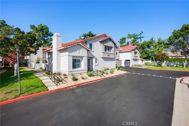 a view of a house with a yard and street view