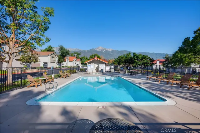 a view of a house with backyard and sitting area