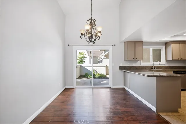 a view of a kitchen with granite countertop wooden floor and a window
