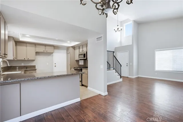 a view of a kitchen with a sink and dishwasher wooden floor