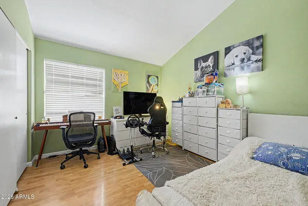a view of a workspace with furniture and a window