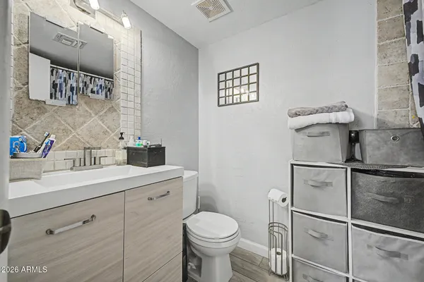 a bathroom with a toilet sink and mirror