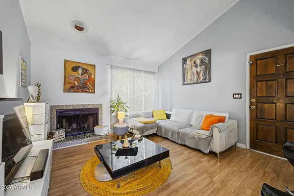 a living room with fireplace furniture and a fireplace