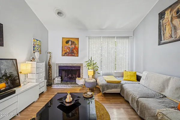 a living room with furniture and a fireplace