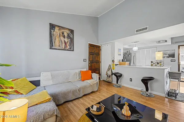 a living room with furniture and wooden floor