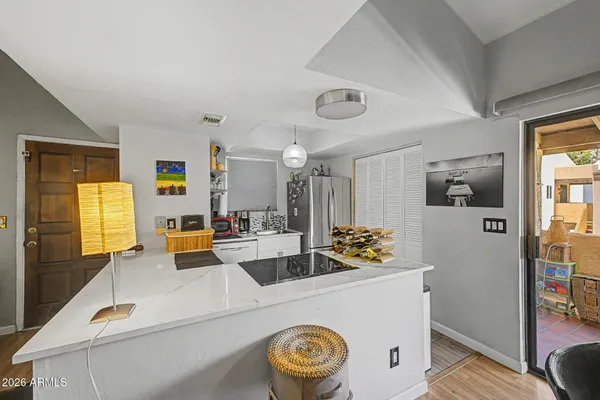 a living room with kitchen island furniture and a window
