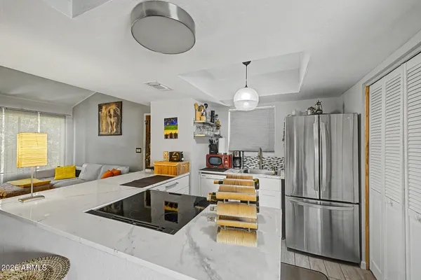 a kitchen that has a refrigerator a sink and a stove