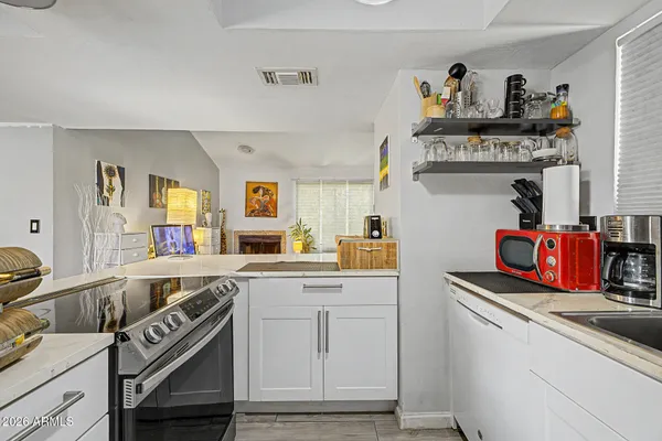 a kitchen with granite countertop a sink and cabinets