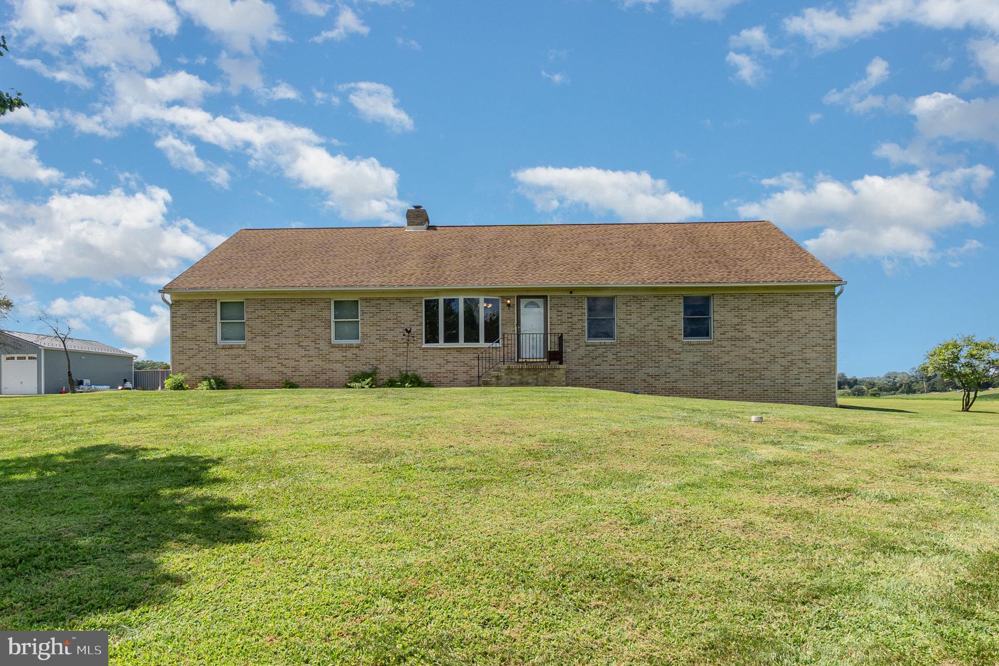 4816 Amos Road White Hall, MD 21161 - Photo 1 of 56 a front view of a house with a garden