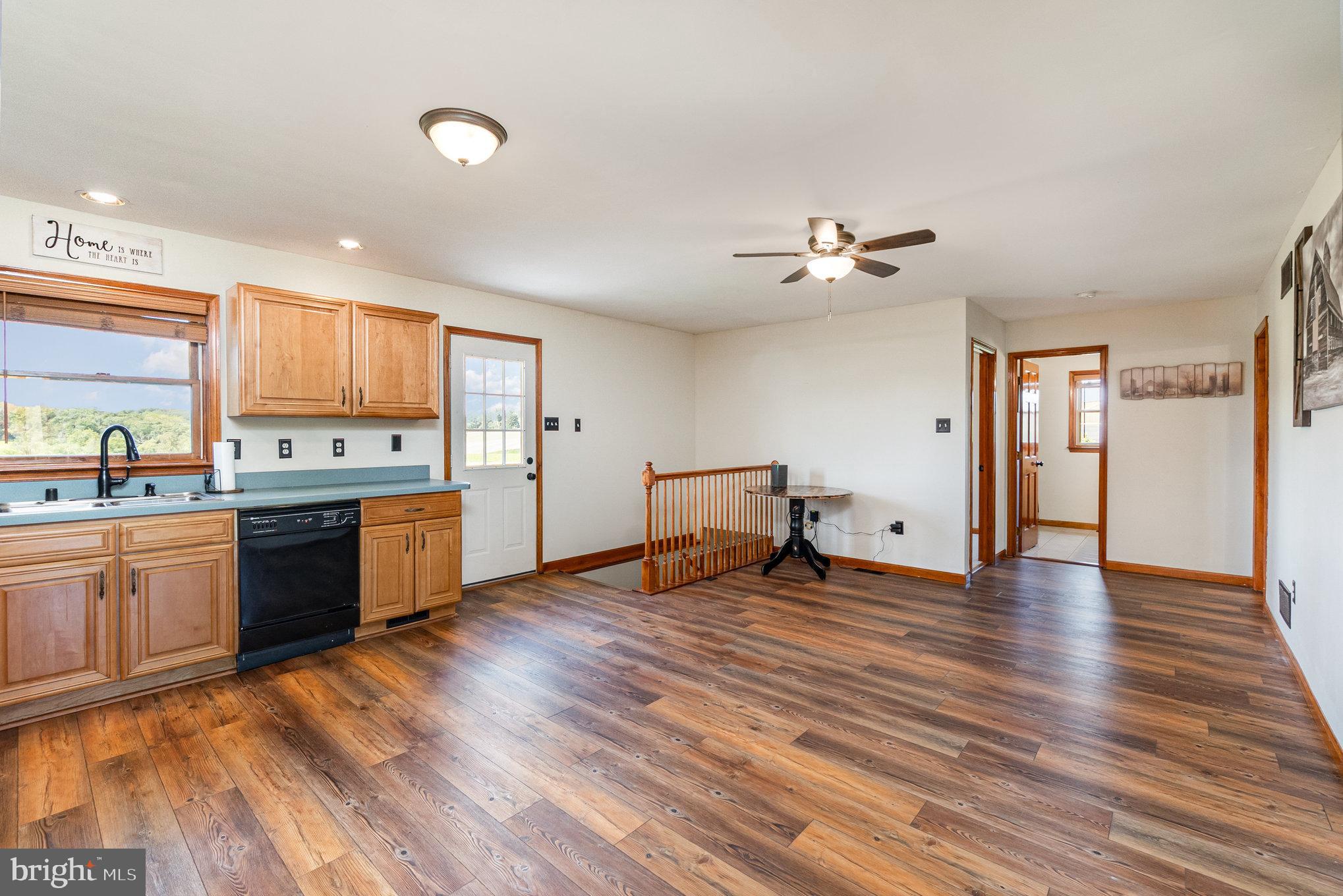 4816 Amos Road White Hall, MD 21161 - Photo 11 of 56 a large kitchen with cabinets wooden floor and stainless steel appliances