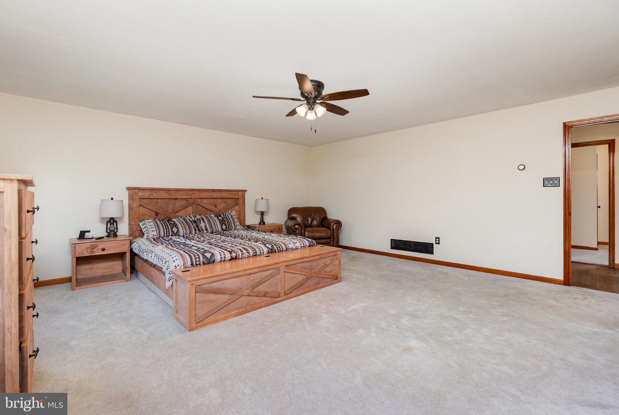 4816 Amos Road White Hall, MD 21161 - Photo 16 of 56 a spacious bedroom with a bed and window