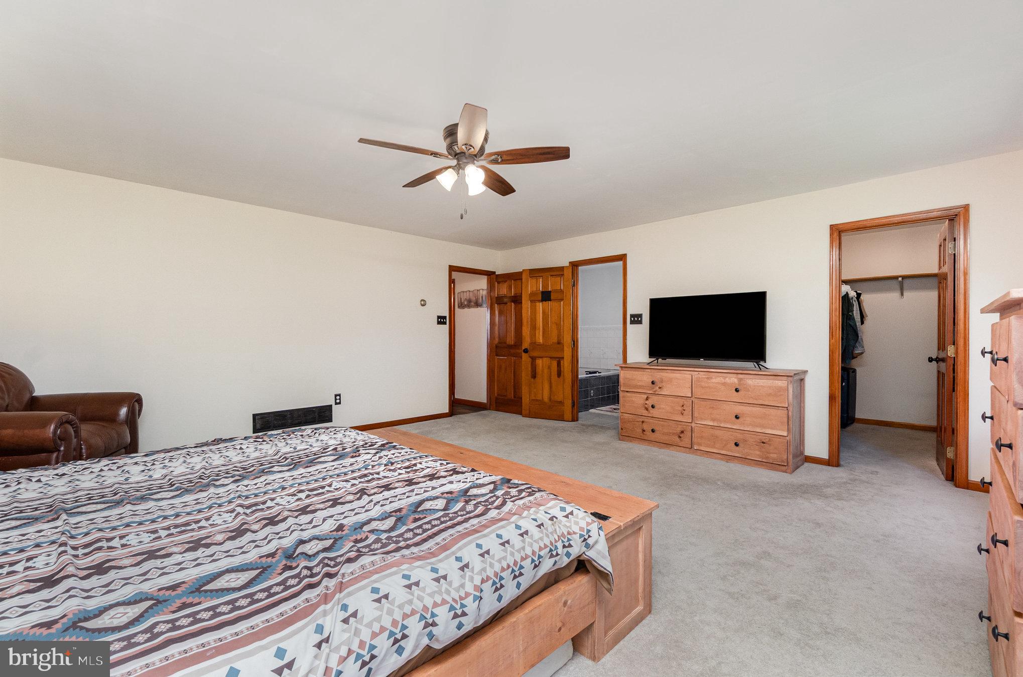 4816 Amos Road White Hall, MD 21161 - Photo 17 of 56 a bedroom with a bed and a flat screen tv