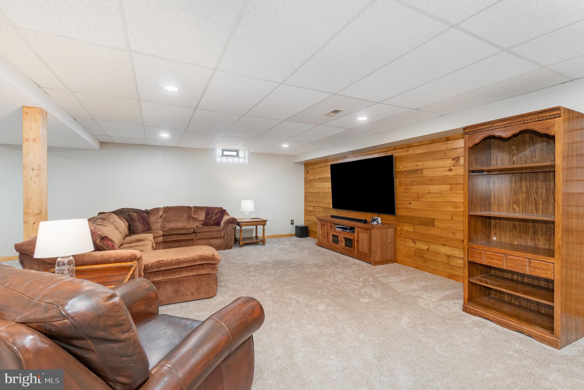 4816 Amos Road White Hall, MD 21161 - Photo 25 of 56 a living room with furniture and a flat screen tv