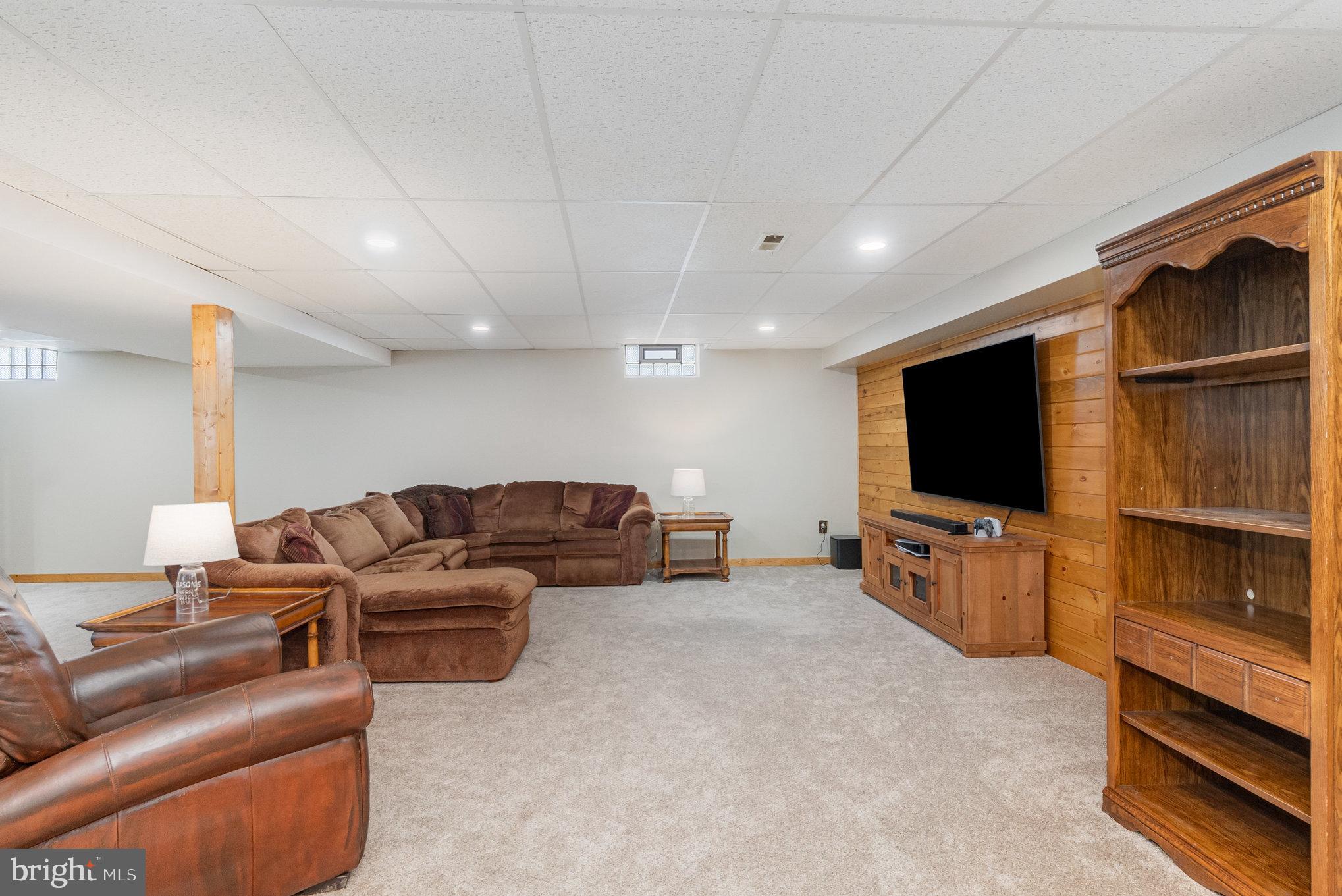 4816 Amos Road White Hall, MD 21161 - Photo 26 of 56 a living room with furniture and a flat screen tv