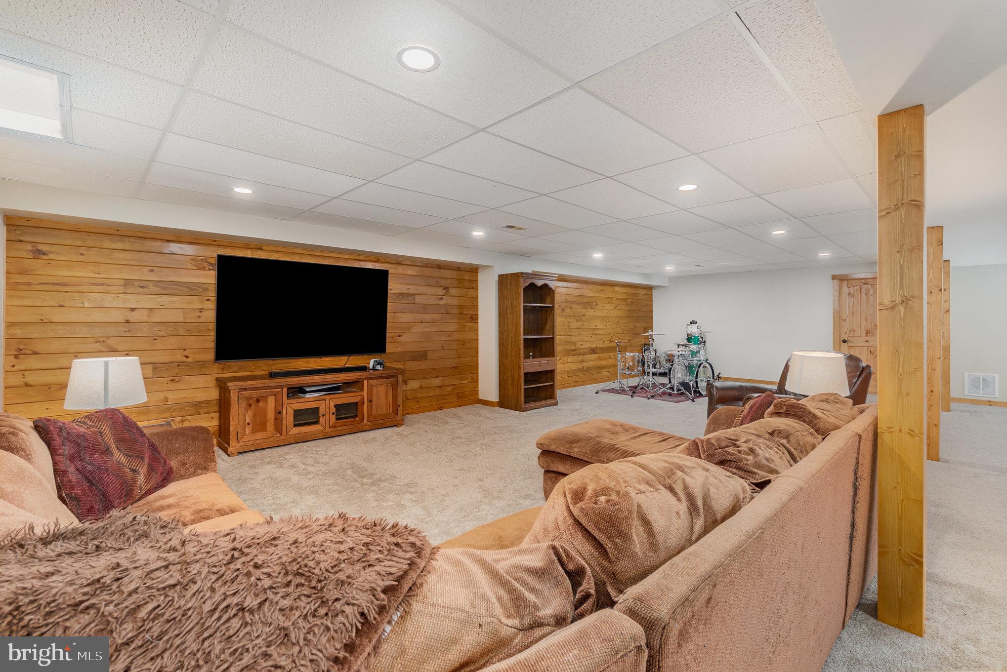 4816 Amos Road White Hall, MD 21161 - Photo 28 of 56 a living room with furniture and a flat screen tv