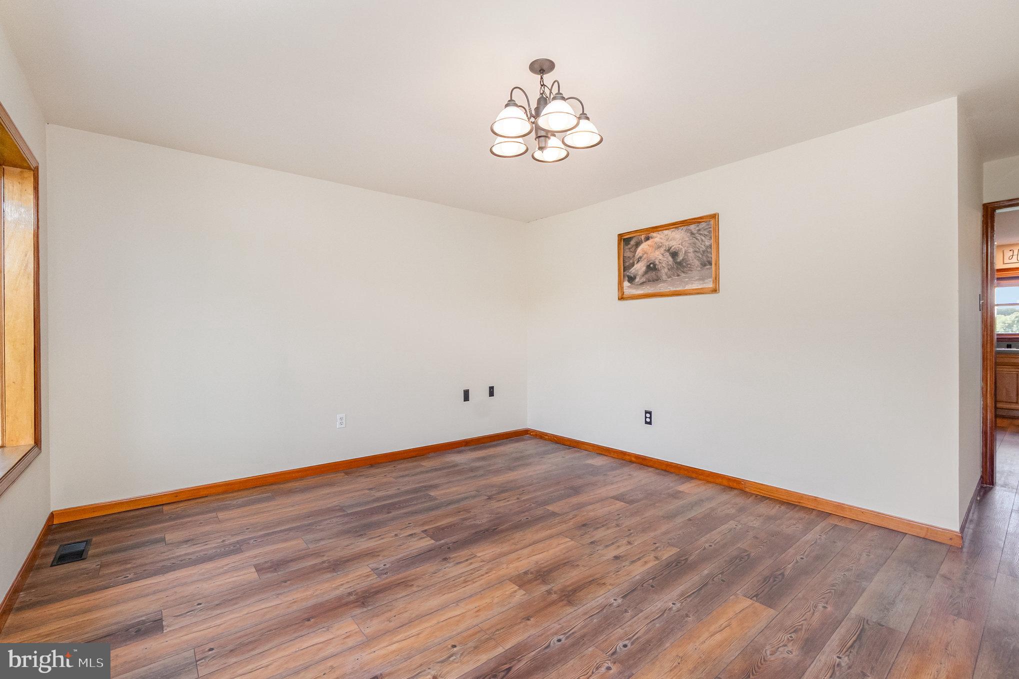 4816 Amos Road White Hall, MD 21161 - Photo 8 of 56 a view of empty room with wooden floor and fan