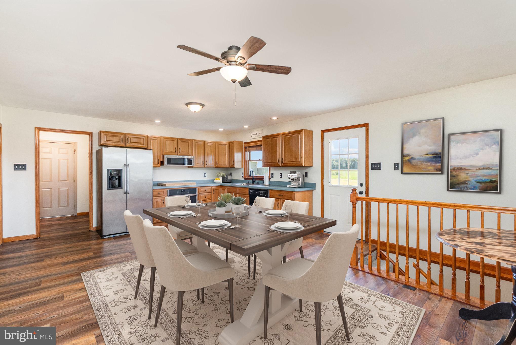 4816 Amos Road White Hall, MD 21161 - Photo 10 of 56 a dining room with furniture a rug and kitchen view