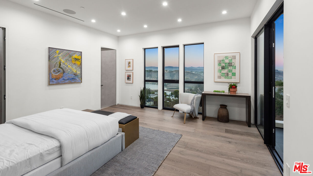 1640 Stradella Road Los Angeles, CA 90077 - Photo 13 of 25 a bedroom with a large bed and a large window