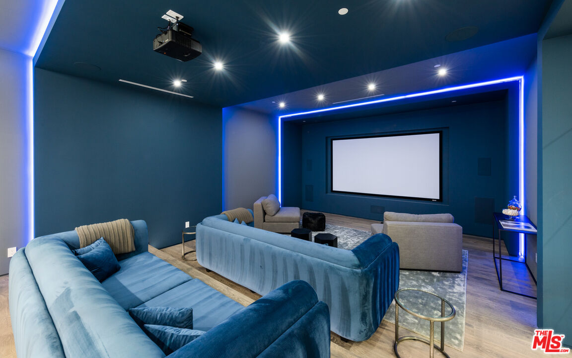 1640 Stradella Road Los Angeles, CA 90077 - Photo 15 of 25 a projector room with a couch and a flat screen tv