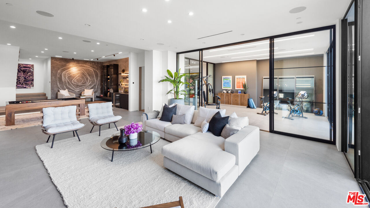 1640 Stradella Road Los Angeles, CA 90077 - Photo 18 of 25 a living room with furniture and a glass door