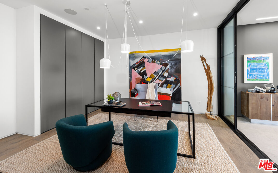 1640 Stradella Road Los Angeles, CA 90077 - Photo 20 of 25 a living room with furniture and a flat screen tv